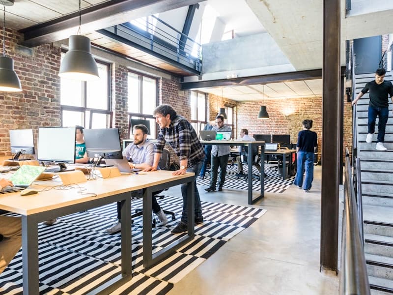 Modern technology workspace with multiple screens showing business data